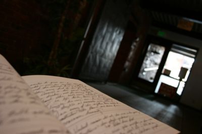 Notebook filled with writing in a dark entryway