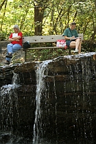 Writers on bench above waterfall