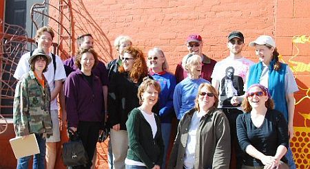 Participants group photo in front of brick wall