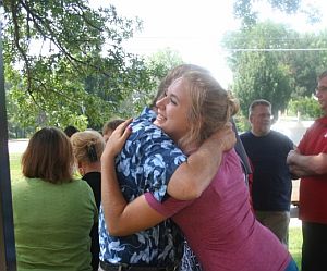 Two people hugging in a crowd